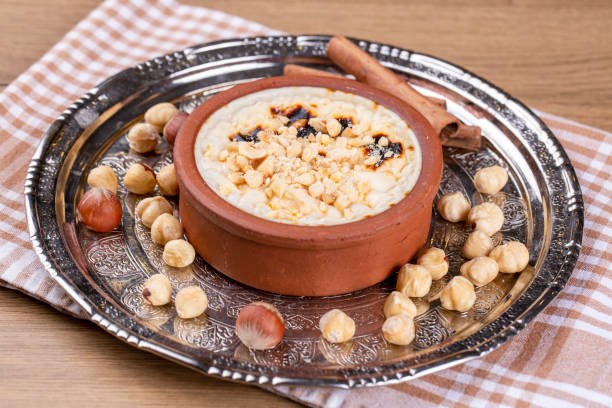 istock Baked rice pudding turkish milky dessert sutlac in earthenware casserole with hazelnuts 1273759786