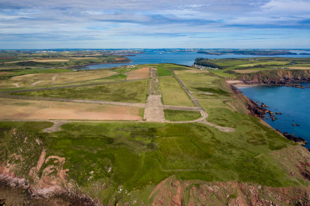 Aerial view of an abandoned airfield Aerial view of an old, abandoned ww2 airfield and runway (RNAS Dale, Wales, UK) milford haven stock pictures, royalty-free photos & images