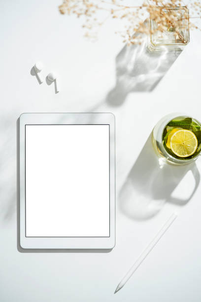 Digital tablet mockup, template on table with cup of herbal tea