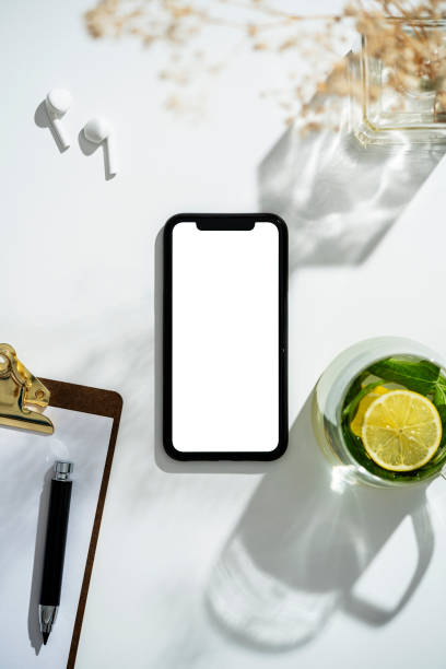 istock Smart phone mockup, template on table with cup of herbal tea 1273760679