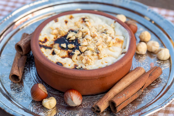 istock Baked rice pudding turkish milky dessert sutlac in earthenware casserole with hazelnuts 1273760826