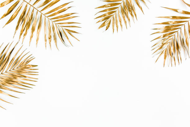 istock Gold tropical palm leaves on white background. Flat lay, top view minimal concept 1273761684