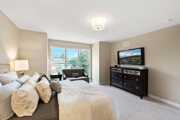 istock Lots of pillows in bright master bedroom 1273765790