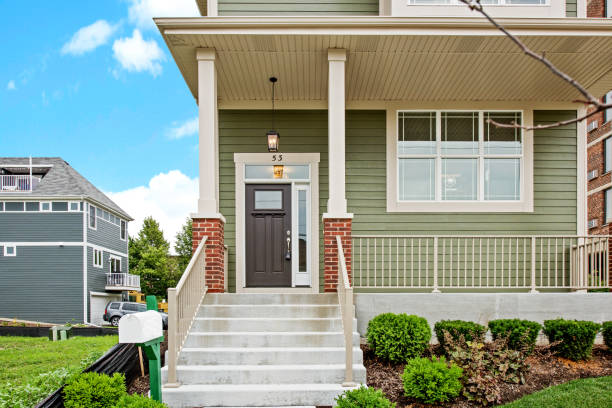 istock Green colored siding with steps leading up to lovely porch 1273765792