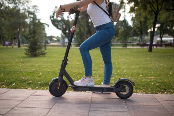 istock Young woman riding electric scooter 1273765947