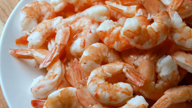 Heap of peeled Cooked shrimps Heap of peeled Cooked shrimps headless shrimp stock pictures, royalty-free photos & images