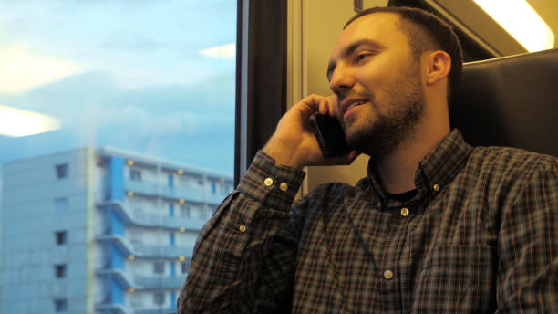 istock Young caucasian man in subway train talking on cellphone 1273771680