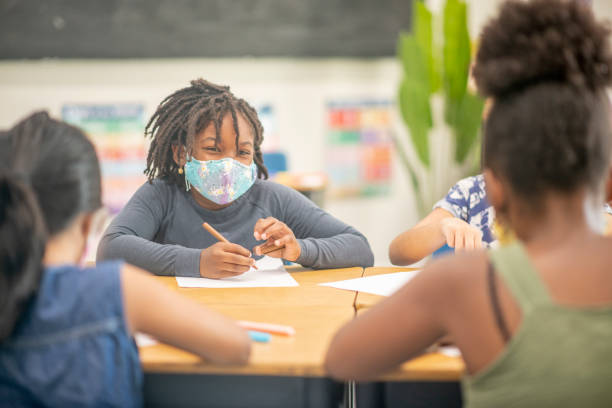 istock Diverse group of elementary students in the classroom during the pandemic 1273781235