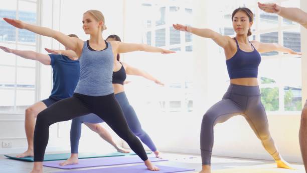 istock Multi ethnic group of people (Asian, Caucasian) in yoga class together 1273783718