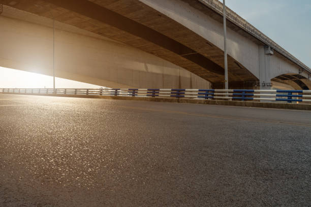 istock empty asphalt road in downtown of modern city during sunrise. 1273789005