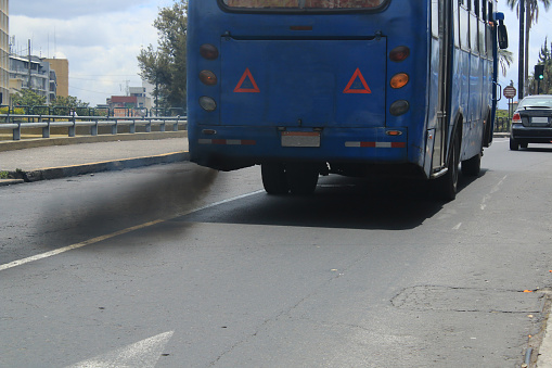 Auto bus polluting the environment with black smog coming from the exhaust pipe