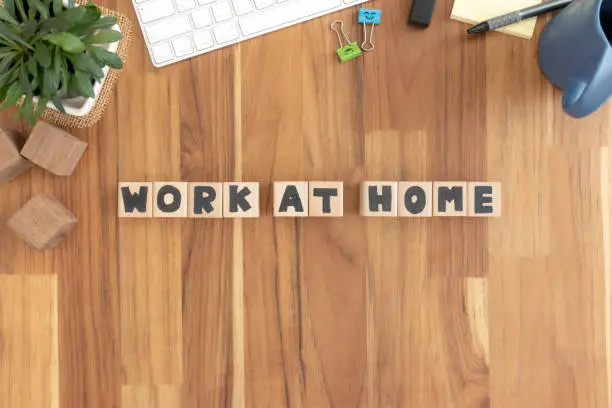 Photo of Work at home, Cubes wooden Lined up into text on the wood desktop vintage white office supplies.