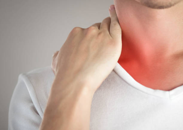 istock Sore throat in a man. Highlighted in red. On a gray background. Close up 1273801454