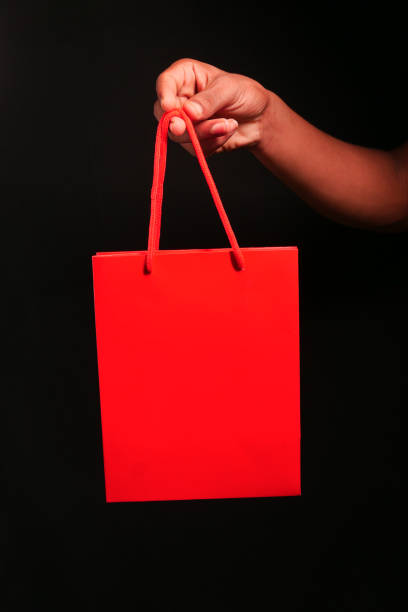 istock red color gift bag isolated on black 1273801521