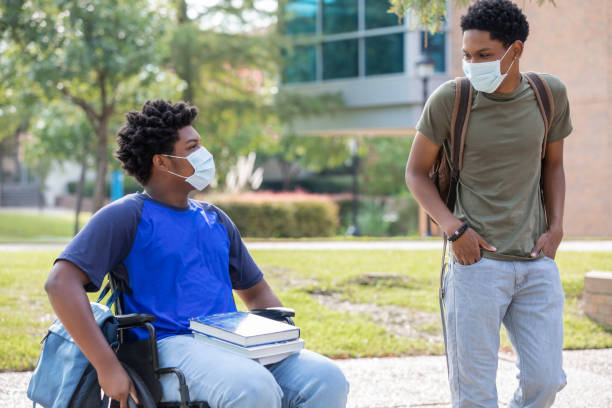 istock One disabled college student walking with friend 1273807731