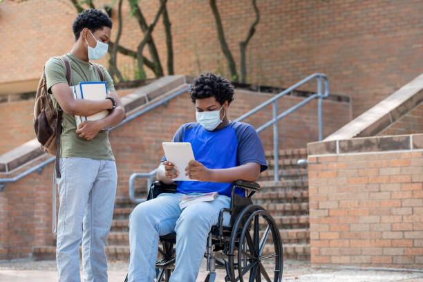 istock Two young adult students standing outside of class 1273807883