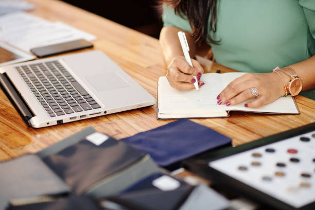 istock Aatelier owner writing in planner 1273810492