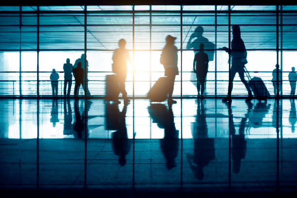 istock Group of Blurred Passenger Walking Through Airport Corridor 1273811333
