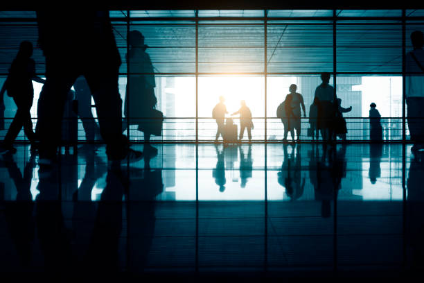istock Group of Blurred Passenger Walking Through Airport Corridor 1273811337