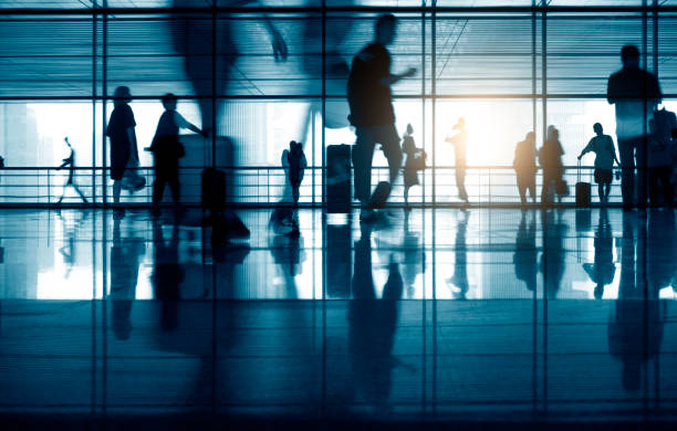 istock Group of Blurred Passenger Walking Through Airport Corridor 1273811349