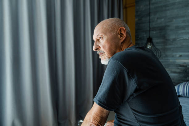 istock Sad wrinkled man sitting lonely in bedroom 1273812465