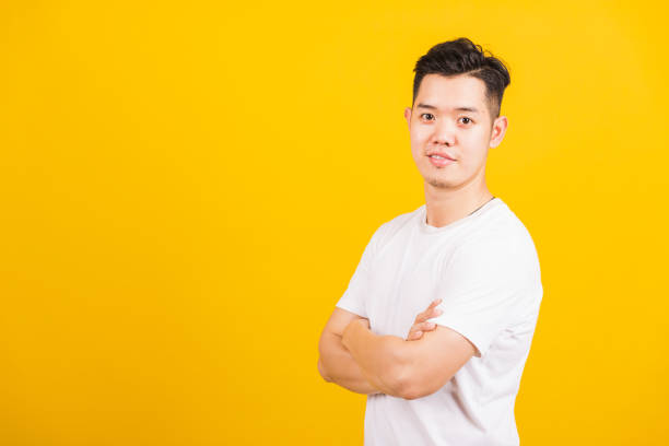 istock handsome young man smiling standing folded or crossed arm 1273812537