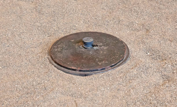 istock Old rusty world war II anti-tank mine in the sand 1273813517