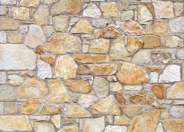 istock White and orange stone wall made of large flat natural rocks. 1273813963