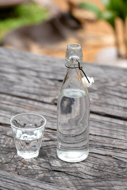 istock Bottle and glass with water on the wooden table 1273815849