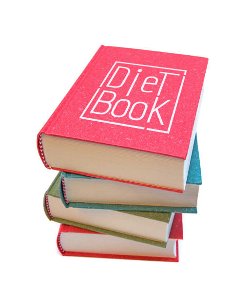 libros de dieta aislados sobre fondo blanco - book stack dieting textbook fotografías e imágenes de stock