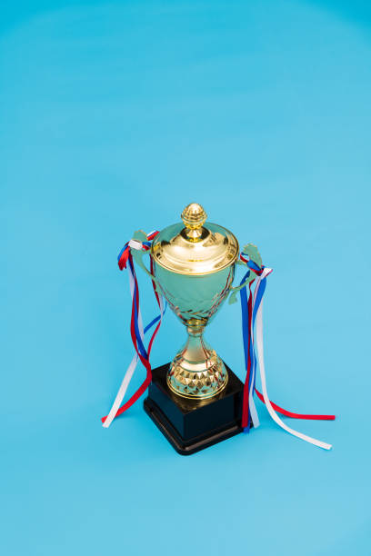 istock Golden trophy on blue background 1273817996