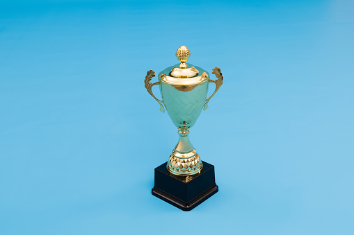 Golden trophy on blue background.