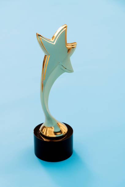 istock Gold star trophy on blue background 1273819205