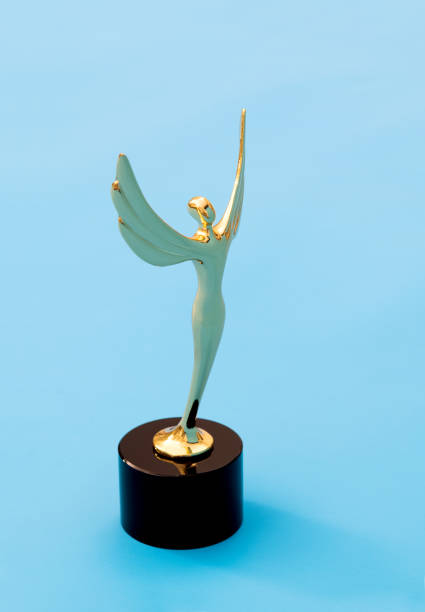 istock Gold figurine trophy on blue background 1273819322