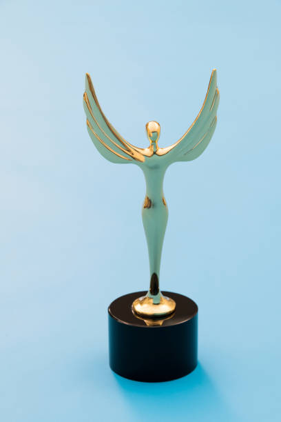 Gold figurine trophy on blue background