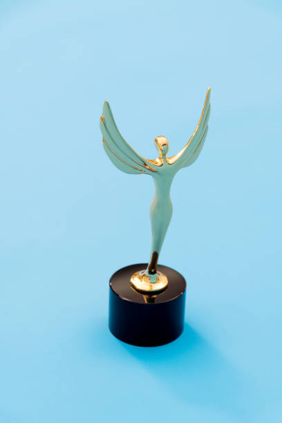 istock Gold figurine trophy on blue background 1273819497