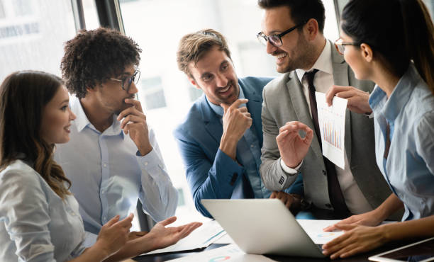 istock Group of business partners discussing documents and ideas at meeting 1273819531