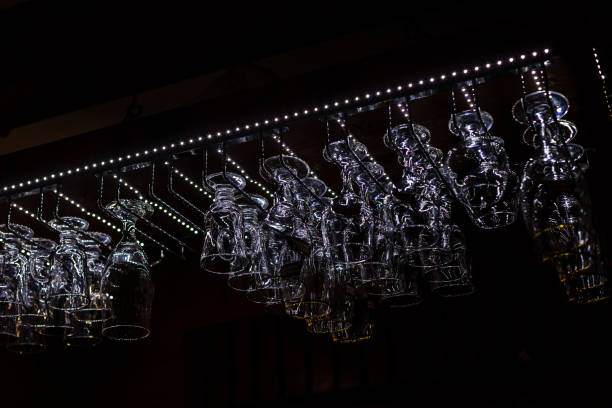 istock Empty glasses for wine above a bar rack in vintage tone, night 1273821114
