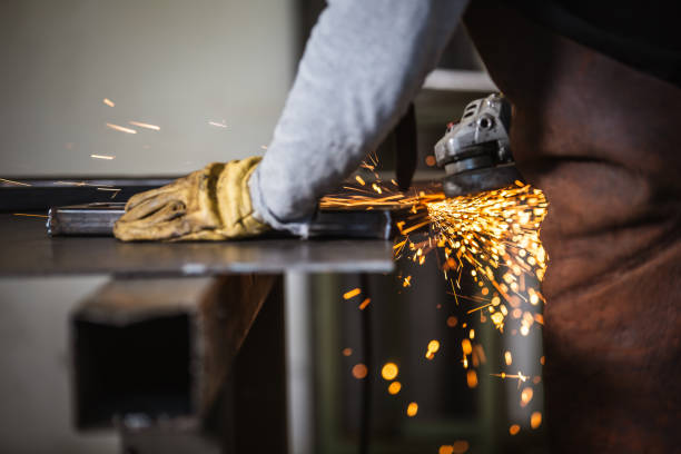 Metal Worker with the grinder Metal Worker with the grinder metal worker stock pictures, royalty-free photos & images