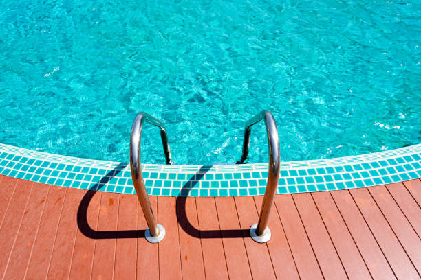 istock Steel ladder in to clear empty swimming pool 1273821276