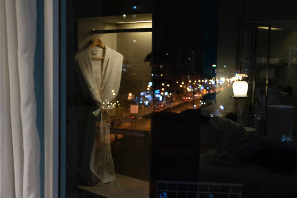 Reflection of bathrobe and night view of street light bokeh stock photo