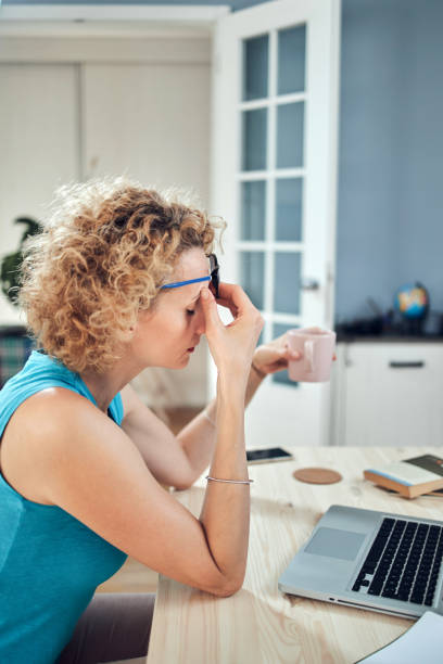 istock Woman working from home and being depressed, tired with headache. Modern concept and problems with freelancers. 1273822989