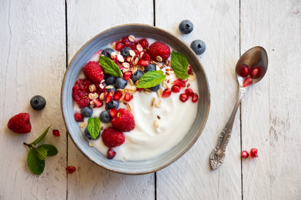 istock Yogurt with fresh fruit and cereals in a bowl, healthy breakfast 1273824277