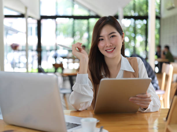 istock Female university student doing her thesis with digital devices in cafe 1273824461