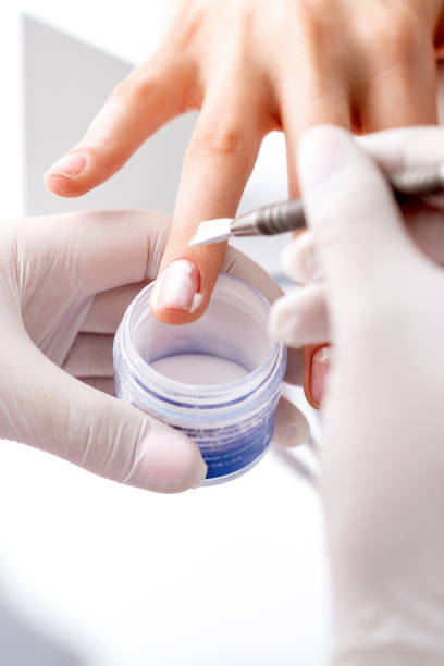 istock Process of applying acrylic powder on the nails 1273826311