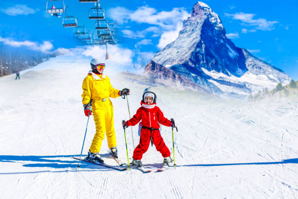 istock Mother and daughter having fun and learning skiing making first steps with mom's support on a ski winter resort at mountain hill. 1273827153