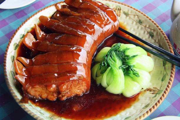 Crocodile meat and boiled cabbage. Chinese cuisine. A beautiful dish in the restaurant. Crocodile tail in a plate.