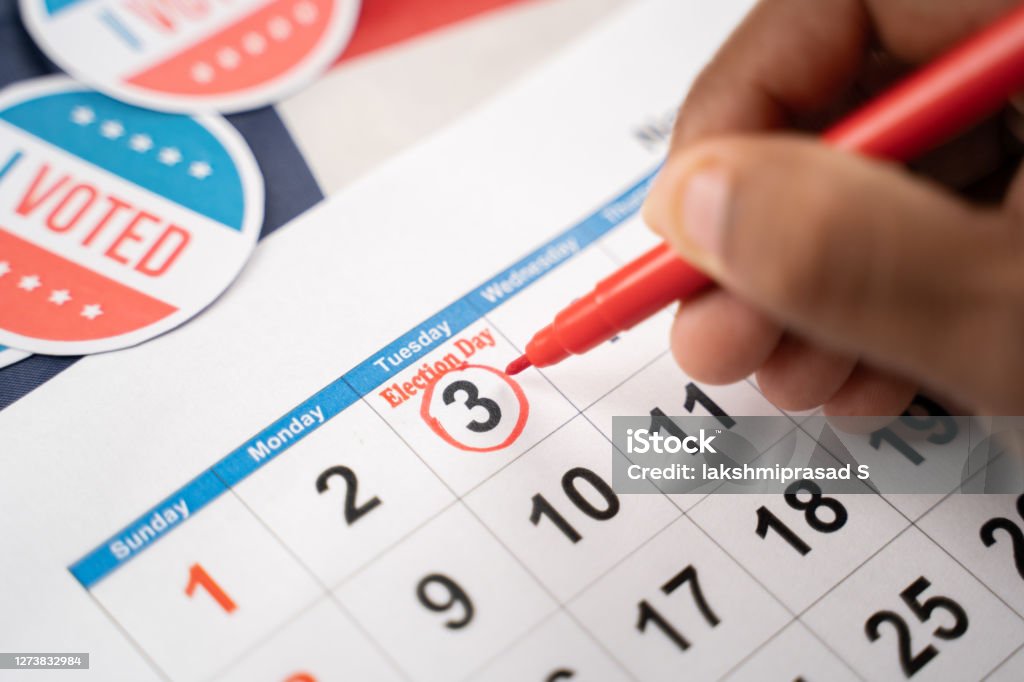 Close up of Hands marking november 3 election day on Calendar as reminder for voting - Concept of reminder for US election. Close up of Hands marking November 3 election day on Calendar as reminder for voting - Concept of reminder for US election Election Stock Photo