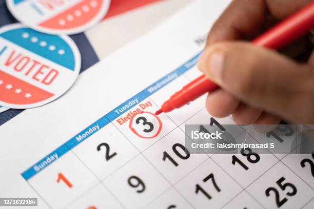 Close Up Of Hands Marking November 3 Election Day On Calendar As Reminder For Voting Concept Of Reminder For Us Election Stock Photo - Download Image Now