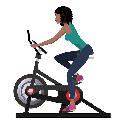 Young, fit girl working out on stationary bike